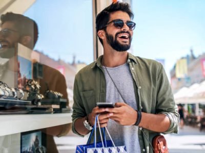 Modern young man enjoying in shopping. Consumerism, fashion, lifestyle concept